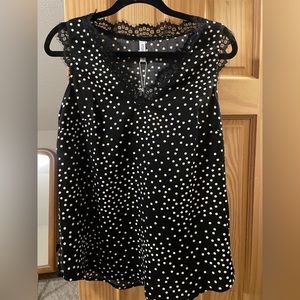 Sleeveless black polka dot top with lace detail